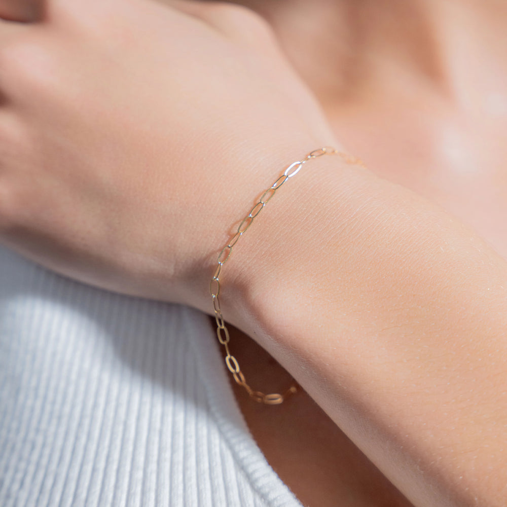 Flat Oval Link 14K gold-filled bracelet worn on wrist